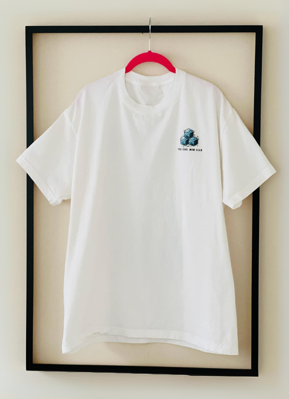 Front view of the white Cool Mom Club Tee by Dass My Best Friend, hanging inside a picture frame. The bold "COOL MOM CLUB" graphic is displayed on the front, highlighting the relaxed fit and stylish design made for confident moms.