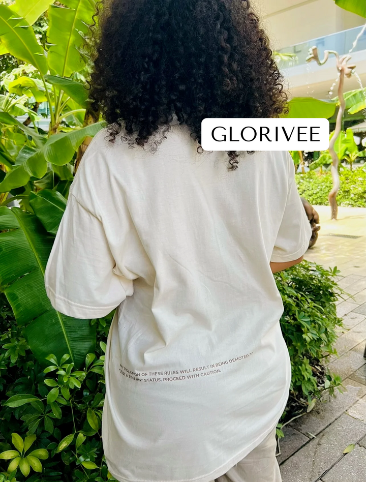 Glorivee wearing the tan "That's My Best Friend" Tee by Dass My Best Friend, frontal view. The tee features a soft, relaxed fit for all-day comfort, with the bold "That's My Best Friend" design printed on both the front and back.