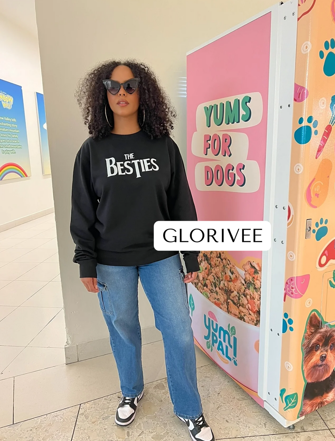 Glorivee wearing the black Besties Crewneck by Dass My Best Friend. The Beatles-inspired Besties design is displayed on the front of the midweight sweater, combining comfort and style for a casual, everyday look.